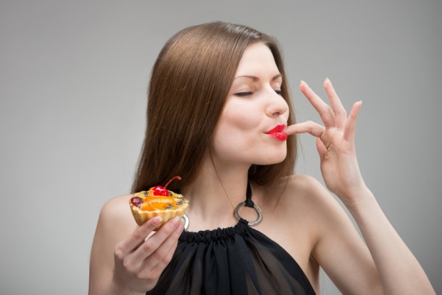 Portrait of young woman enjoying the cake